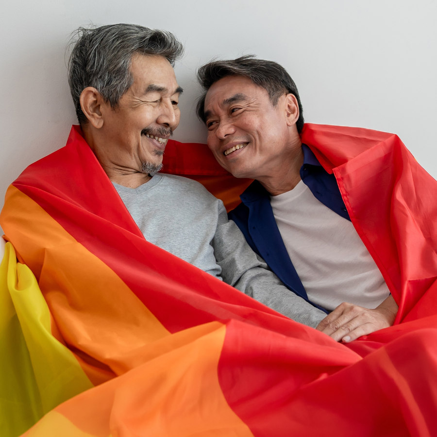Two people with pride flag sweaters